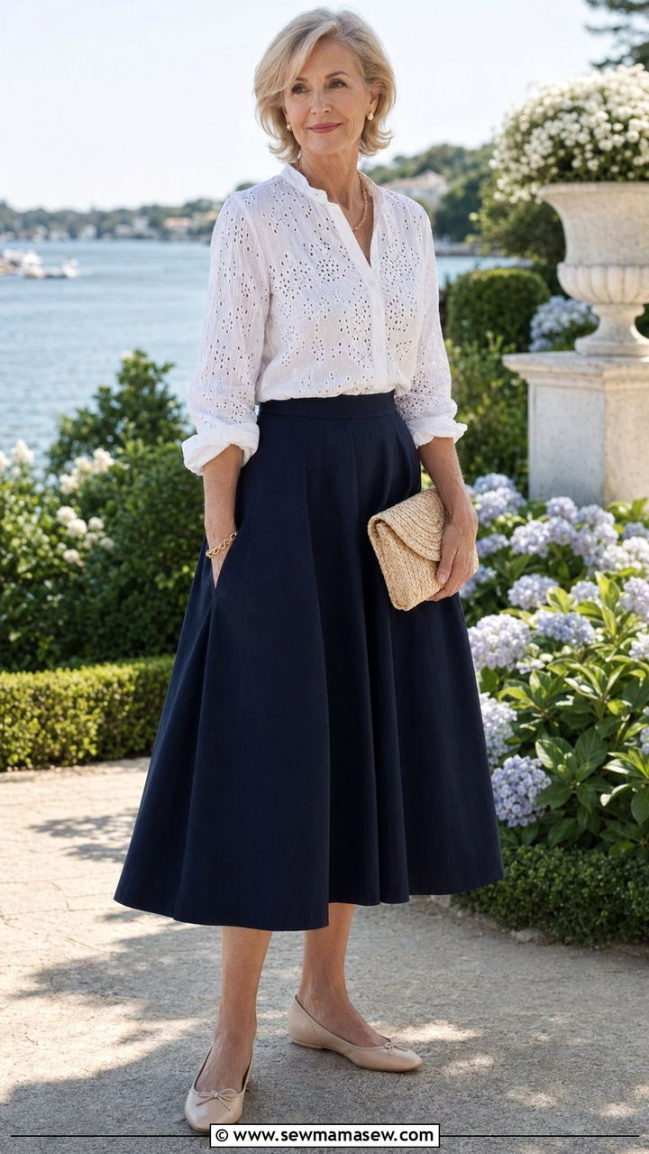 White eyelet lace blouse with a navy A line midi skirt - 35 Old money outfit ideas for women over 60